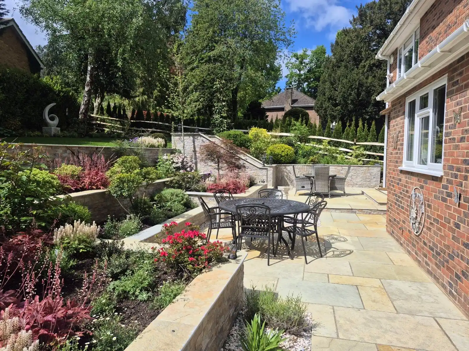 Landscaped patio with natural stone paving in Kent by Cyril Ernest Landscapes